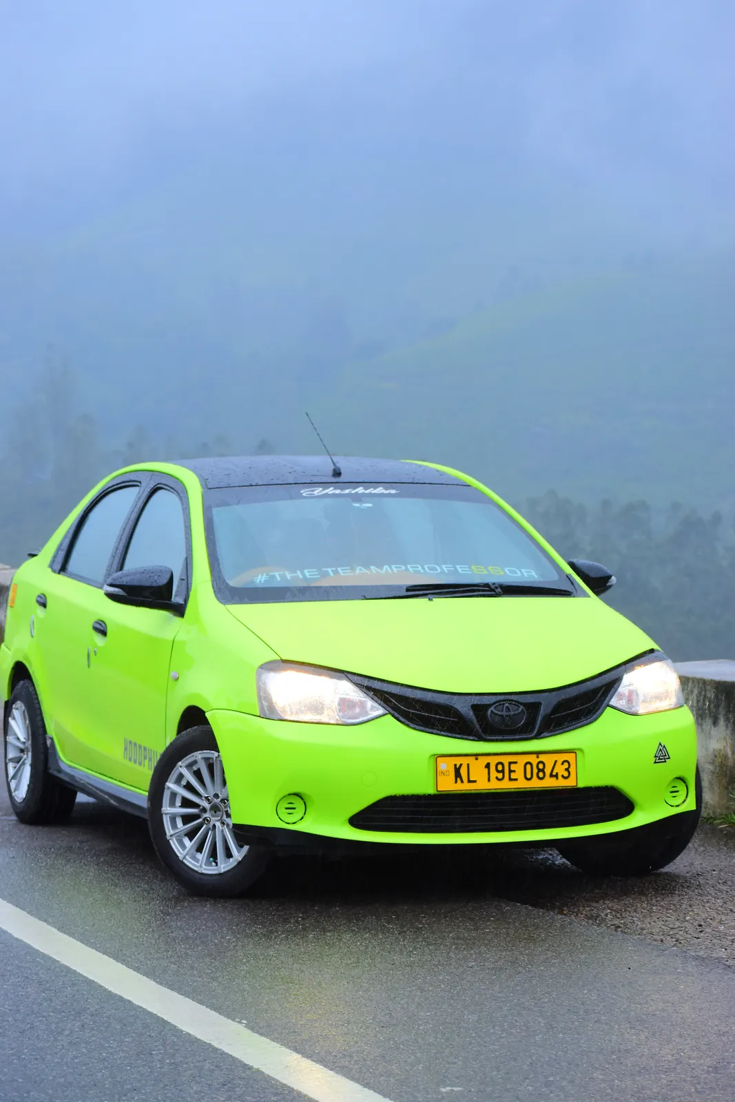 Green Munnar Trip Makers taxi on a misty high-range road